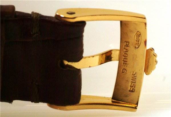 The image shows a close-up of the gold buckle on the strap of a Rolex Cellini 4012 Men's Yellow Gold White Dial 4012 Men's Yellow Gold White Dial watch.