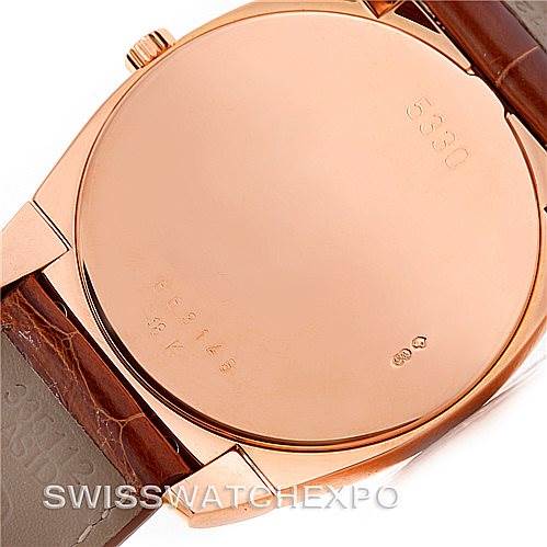 The image shows the back case of a Rolex Cellini 5330 Men's Rose Gold Grey Dial 5330 Men's Rose Gold Grey Dial watch, focusing on its gold surface and leather strap.