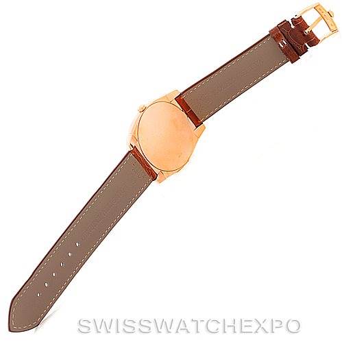 This image shows a top view of a Rolex Cellini 5330 Men's Rose Gold Grey Dial 5330 Men's Rose Gold Grey Dial watch with a brown leather strap and a gold case.