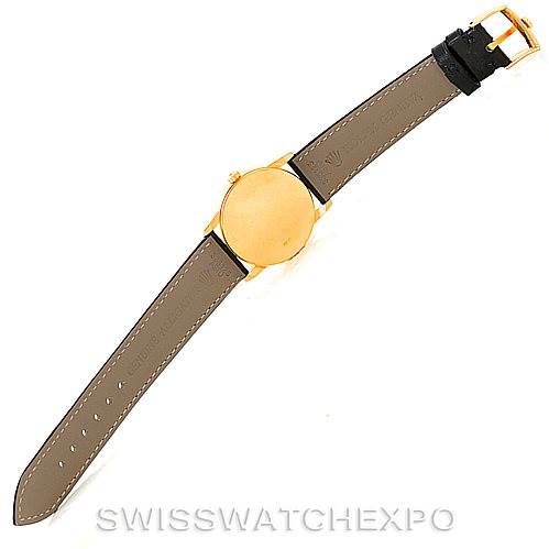 This Rolex Cellini 5116 Men's Yellow Gold Black Dial 5116 Men's Yellow Gold Black Dial watch is shown from the back, displaying its golden case and brown leather strap with a buckle.