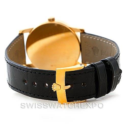 This image shows the rear view of a Rolex Cellini 5116 Men's Yellow Gold Black Dial 5116 Men's Yellow Gold Black Dial watch, focusing on the leather strap and gold buckle with the Rolex emblem.