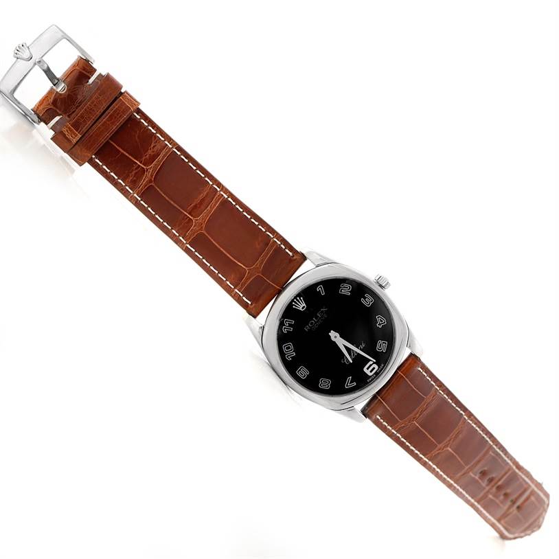 The Rolex Cellini 4233 Men's White Gold Black Dial 4233 Men's White Gold Black Dial watch is shown from a top-down angle, displaying its black dial and brown leather strap.