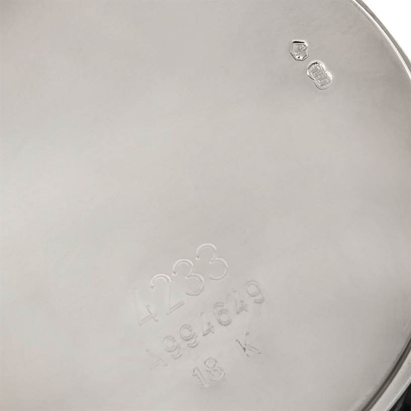 The image shows the engraved case back of a Rolex Cellini 4233 Men's White Gold Black Dial 4233 Men's White Gold Black Dial watch, featuring model and serial numbers.