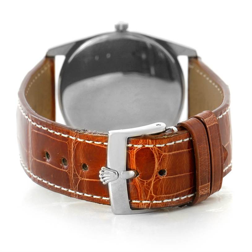 The image shows the back of the Rolex Cellini 4233 Men's White Gold Black Dial 4233 Men's White Gold Black Dial watch and its brown leather strap with stitching and a metal buckle.