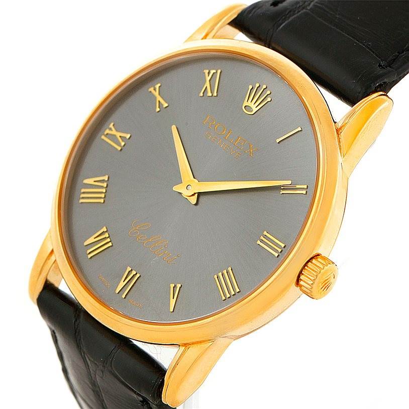 The image shows a close-up angle of the Rolex Cellini 5116 Men's Yellow Gold Grey Dial 5116 Men's Yellow Gold Grey Dial watch, highlighting its face, gold case, crown, and black leather strap.