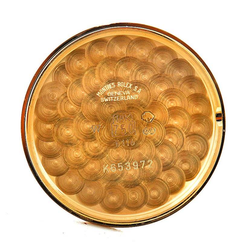 This is the inner case back of a Rolex Cellini 5116 Men's Yellow Gold Grey Dial 5116 Men's Yellow Gold Grey Dial watch, showcasing inscriptions and hallmarking details.