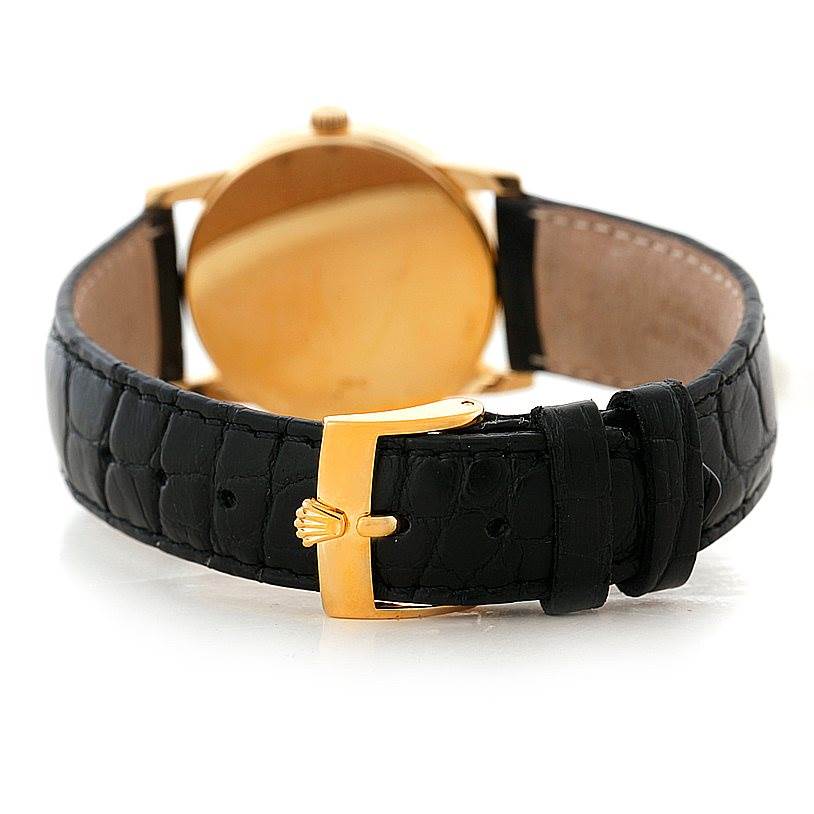 The image shows the rear view of a Rolex Cellini 5116 Men's Yellow Gold Grey Dial 5116 Men's Yellow Gold Grey Dial watch, focusing on its black leather strap and gold buckle.