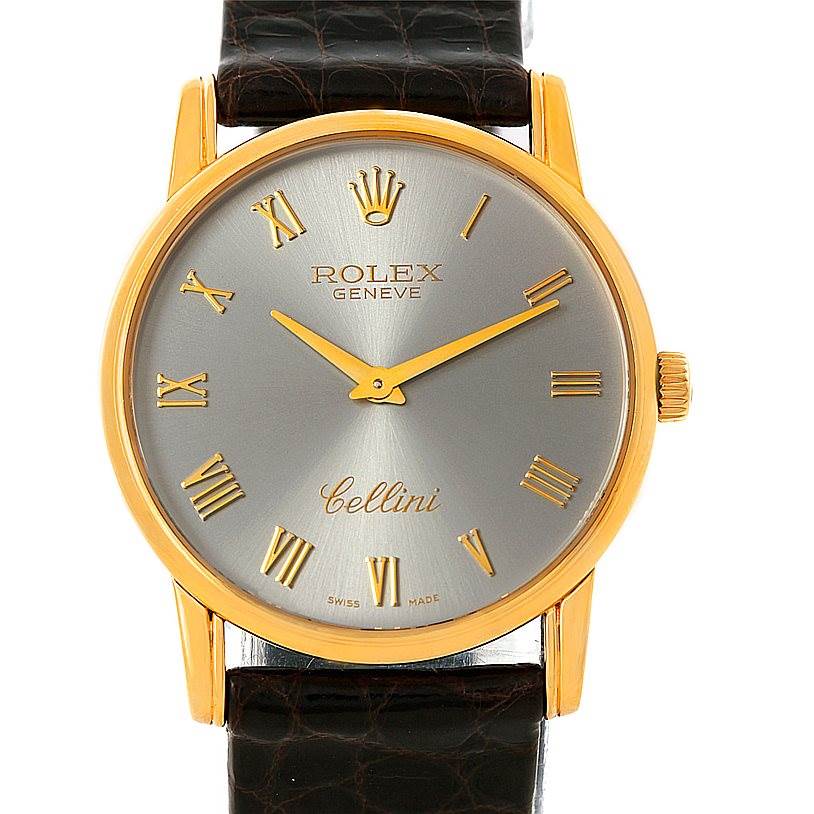The Rolex Cellini 5116 Men's Yellow Gold Grey Dial 5116 Men's Yellow Gold Grey Dial watch is shown from a front angle, displaying its face, crown, hands, and leather strap.