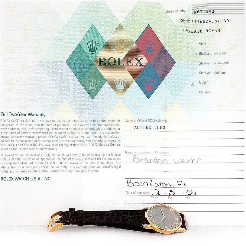 The image shows a Rolex Cellini 5116 Men's Yellow Gold Grey Dial 5116 Men's Yellow Gold Grey Dial watch from an overhead angle, alongside its warranty card and documentation.