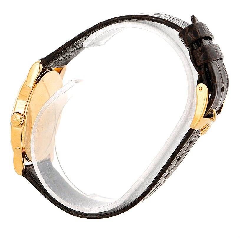 This side-angle view shows the case, crown, and leather strap of the Rolex Cellini 5116 Men's Yellow Gold Grey Dial 5116 Men's Yellow Gold Grey Dial watch, highlighting its gold accents.