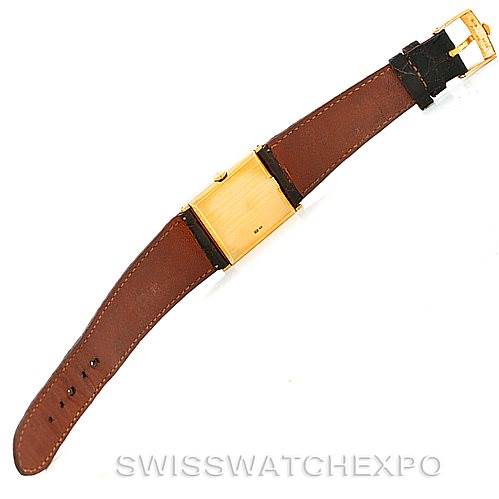 The image shows a top view of a Rolex Cellini 4127 Men
s Yellow Gold Brown Dial 4127 Men
s Yellow Gold Brown Dial watch with a brown leather strap and a gold-toned rectangular face.