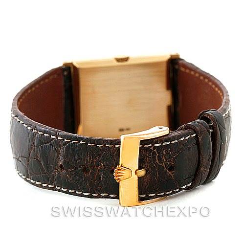 The image shows the back view of a Rolex Cellini 4127 Men
s Yellow Gold Brown Dial 4127 Men
s Yellow Gold Brown Dial watch with its brown leather strap and gold-tone buckle.