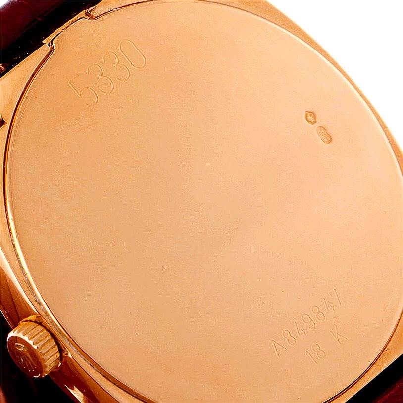 The image shows the back cover of a Rolex Cellini 5330 Men
s Rose Gold White Dial 5330 Men
s Rose Gold White Dial watch, highlighting engravings and the crown.