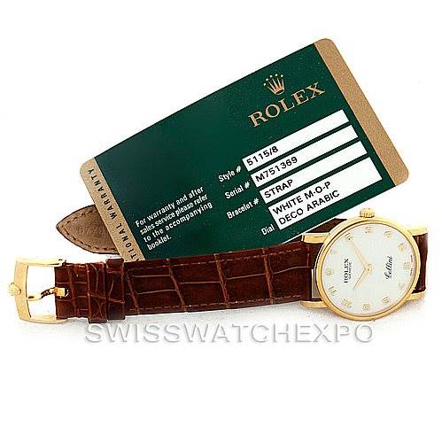 This image shows the Rolex Cellini 5115 Men's Yellow Gold Mother of Pearl Dial 5115 Men's Yellow Gold Mother of Pearl Dial watch, including its face, strap, and accompanying warranty card from a top-down angle.