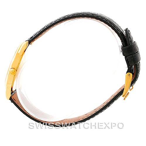 This image shows a side view of the Rolex Cellini 5116 Men's Yellow Gold Black Dial 5116 Men's Yellow Gold Black Dial watch, highlighting its gold case, crown, and black leather strap.