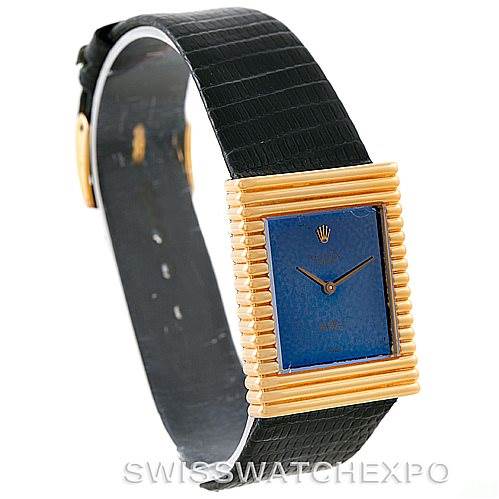 The Rolex Cellini 4012 Men's Yellow Gold Blue Dial 4012 Men's Yellow Gold Blue Dial watch is shown at an angled view highlighting its black strap and rectangular gold-ridged blue face.