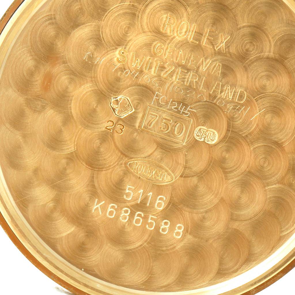 This image shows the interior case back of a Rolex Cellini 5116 Men's Yellow Gold Beige Dial 5116 Men's Yellow Gold Beige Dial model, featuring engraved markings and hallmarks.