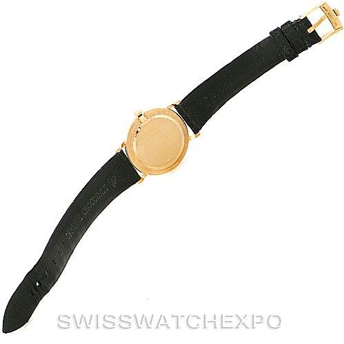 The image shows a Rolex Cellini 5112 Men
s Yellow Gold Champagne Dial 5112 Men
s Yellow Gold Champagne Dial watch from a top-down angle, focusing on the watch face and black strap.