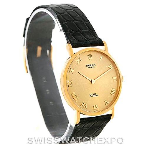 The image shows a Rolex Cellini 5112 Men
s Yellow Gold Champagne Dial 5112 Men
s Yellow Gold Champagne Dial watch from a front angle, highlighting its golden dial, and black strap.
