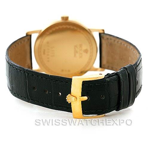 The image shows the back view of a Rolex Cellini 5115 Men
s Yellow Gold Champagne Dial 5115 Men
s Yellow Gold Champagne Dial watch, focusing on the leather strap and gold buckle.