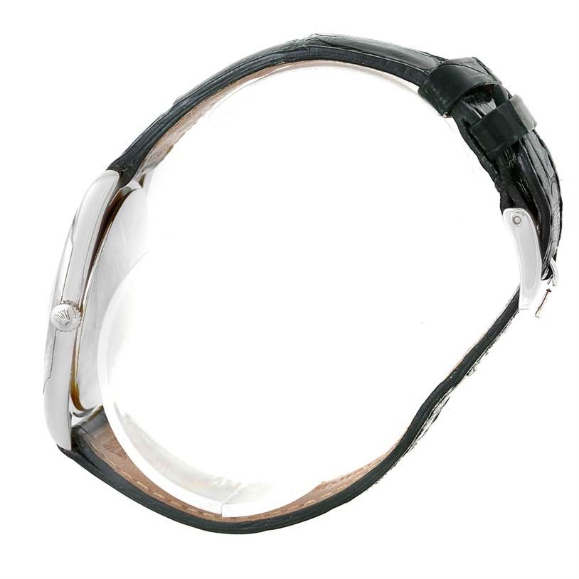 The image shows a side view of a Rolex Cellini 4233 Men
s White Gold Black Dial 4233 Men
s White Gold Black Dial watch, highlighting its case, crown, and leather strap with buckle.