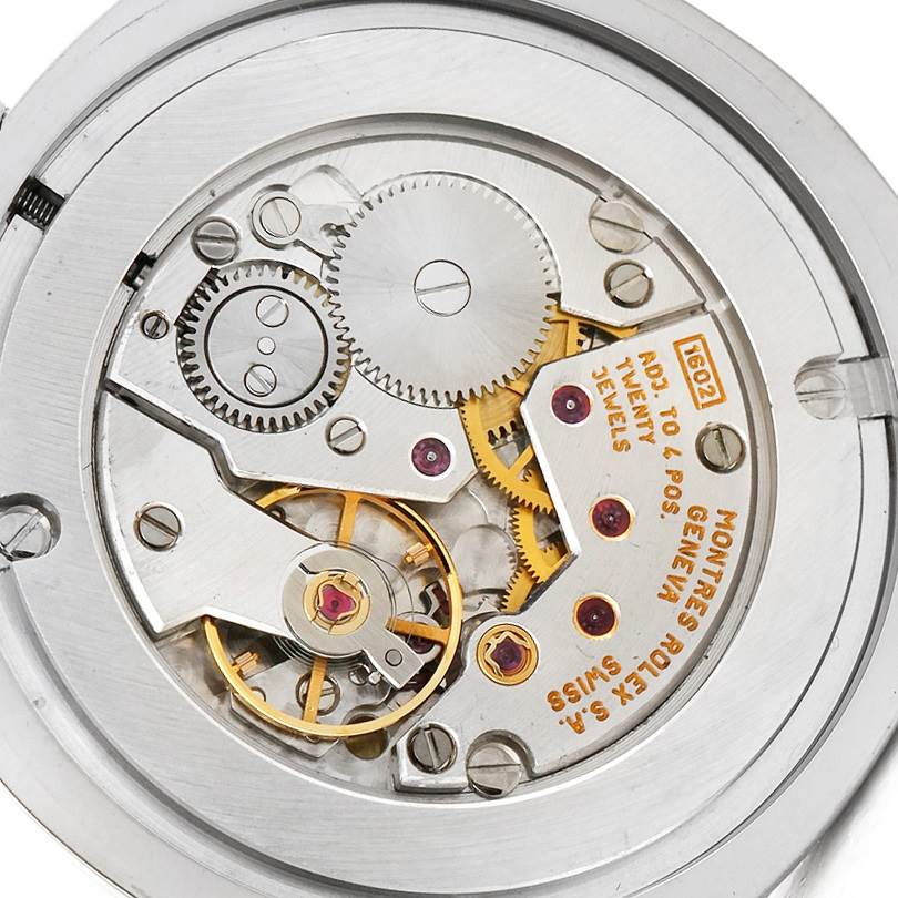 This image shows the inner mechanism, including gears and jewels, of a Rolex Cellini 4233 Men
s White Gold Black Dial 4233 Men
s White Gold Black Dial watch from a close-up angle.