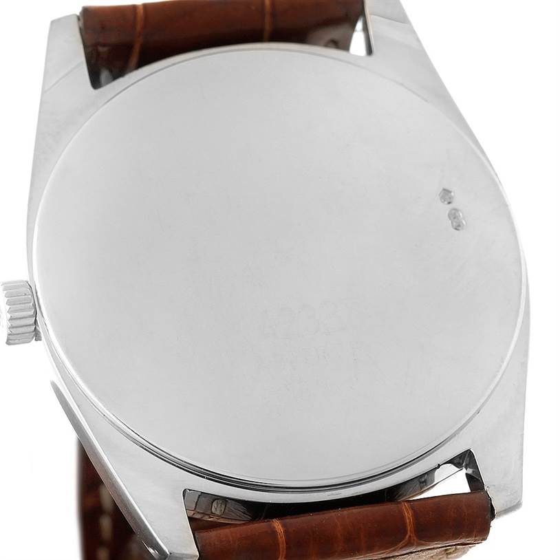 The image shows the back case, crown, and brown leather strap of a Rolex Cellini 4233 Men
s White Gold Black Dial 4233 Men
s White Gold Black Dial watch.