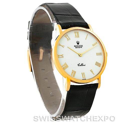 The image shows a side-angle view of a Rolex Cellini 5112 Men's Yellow Gold White Dial 5112 Men's Yellow Gold White Dial watch, highlighting its round gold case, white dial with Roman numerals, and black leather strap.