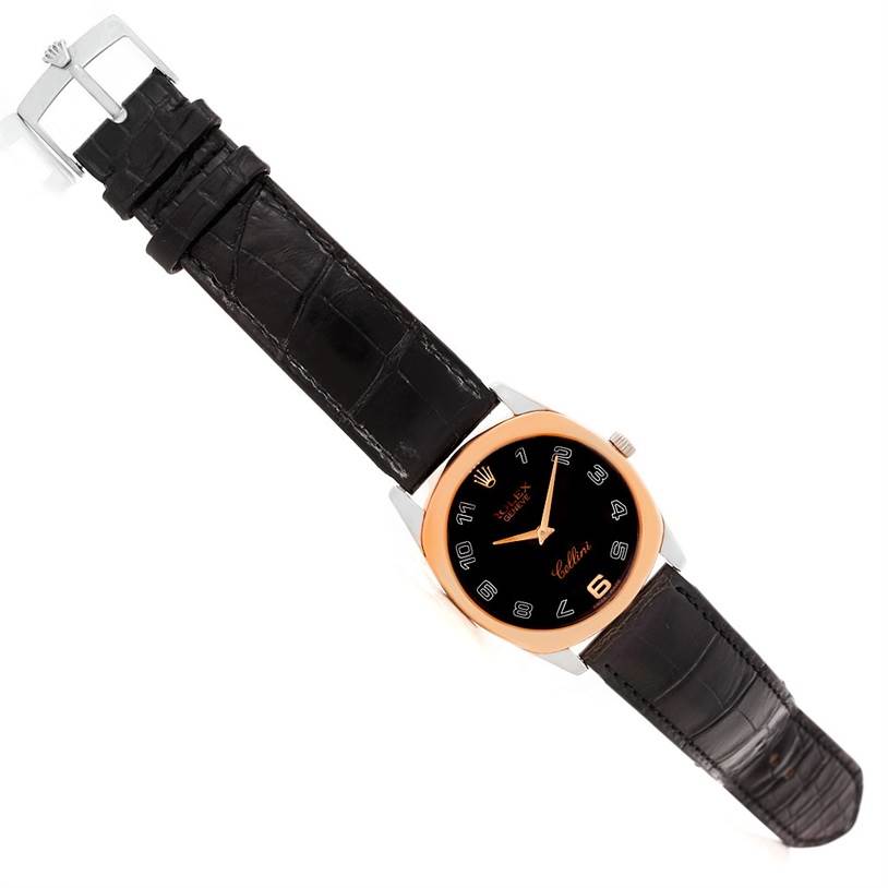 This image shows a top-down view of the Rolex Cellini 4233 Men's White Gold Black Dial 4233 Men's White Gold Black Dial watch, highlighting its black strap, rose gold bezel, and black dial.