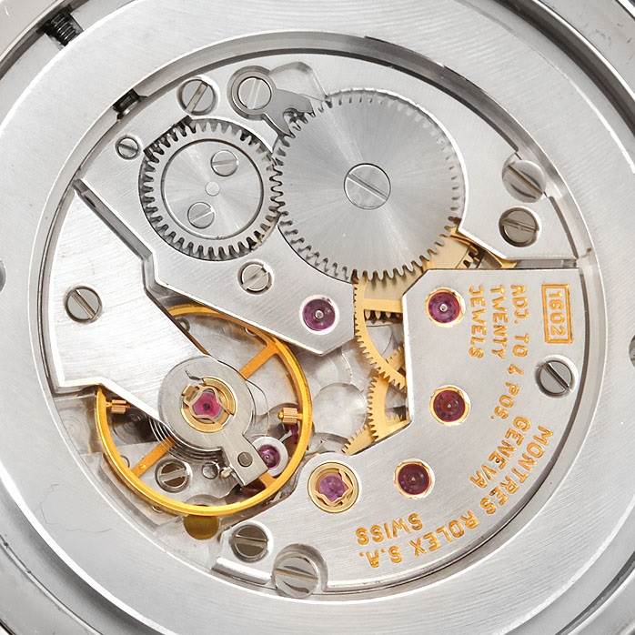 This image shows the intricate internal mechanics of the Rolex Cellini 4233 Men's White Gold Black Dial 4233 Men's White Gold Black Dial watch movement from a close-up angle.