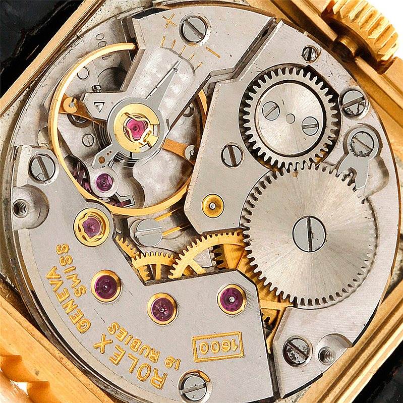 This image shows a close-up of the intricate internal mechanical components of a Rolex Cellini 4012 Men's Yellow Gold Black Dial 4012 Men's Yellow Gold Black Dial watch, highlighting gears and jewels.