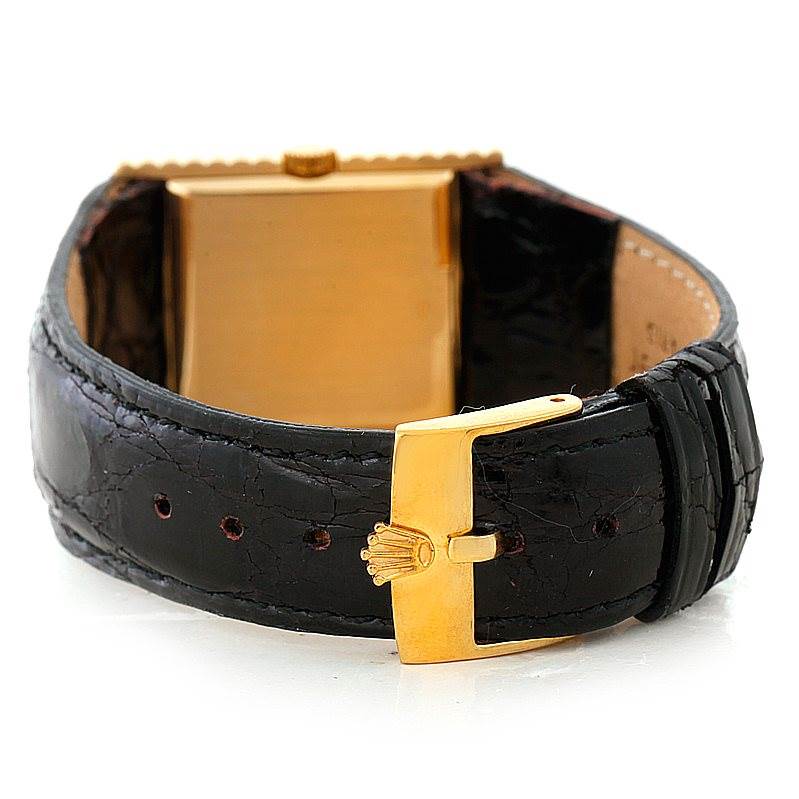 The image shows the back view of a Rolex Cellini 4012 Men's Yellow Gold Black Dial 4012 Men's Yellow Gold Black Dial watch, highlighting the black leather strap and gold buckle with the Rolex logo.