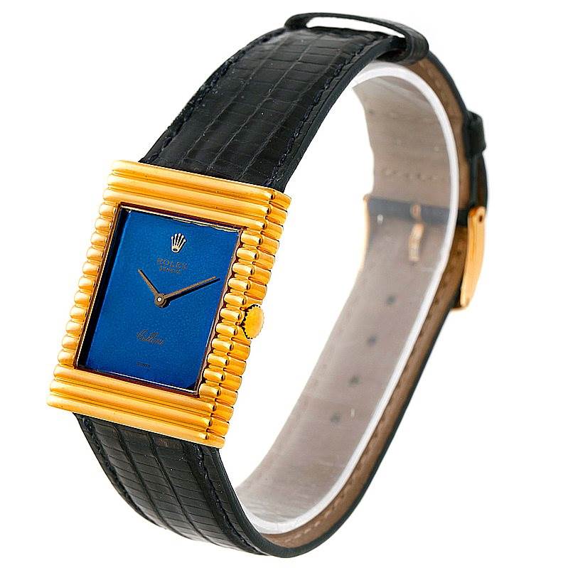 The Rolex Cellini 4012 Men's Yellow Gold Blue Dial 4012 Men's Yellow Gold Blue Dial watch is shown at an angle highlighting the blue dial, gold casing, crown, and black leather strap.