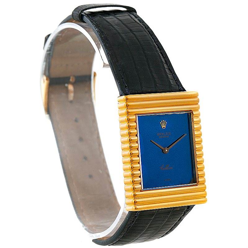 The image shows a side angle of a Rolex Cellini 4012 Men's Yellow Gold Blue Dial 4012 Men's Yellow Gold Blue Dial watch, highlighting its black leather strap, blue dial, and gold rectangular bezel.