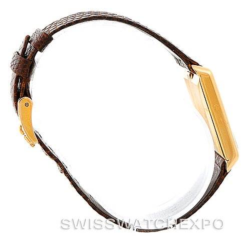 The Rolex Cellini 4105 Men's Yellow Gold Silver Dial 4105 Men's Yellow Gold Silver Dial model watch is shown from a side view, highlighting the case, clasp, and leather strap.