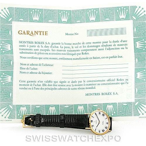 The image shows a Rolex Cellini 4112 Men's Yellow Gold Silver Dial 4112 Men's Yellow Gold Silver Dial watch positioned horizontally with a warranty certificate placed upright in the background.