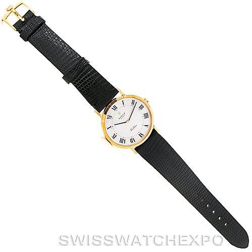 The Rolex Cellini 4112 Men's Yellow Gold Silver Dial 4112 Men's Yellow Gold Silver Dial watch is displayed face-up, showing its white dial with Roman numerals, black leather strap, and gold buckle.