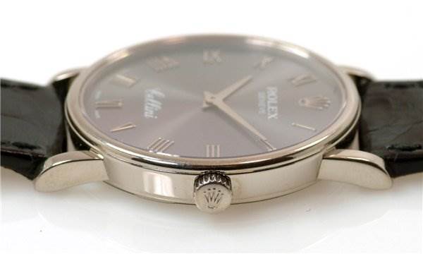 The image shows a side angle of the Rolex Cellini 5115/9 Men
s White Gold Grey Dial 5115/9 Men
s White Gold Grey Dial watch, highlighting the crown and part of the dial with the strap.