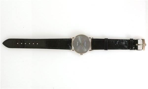 The image shows a Rolex Cellini 5115/9 Men
s White Gold Grey Dial 5115/9 Men
s White Gold Grey Dial watch laid flat, displaying its black leather strap, dial, and buckle from a top-down angle.