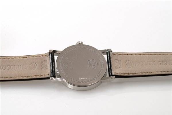 The image shows the back side and leather straps of a Rolex Cellini 5115/9 Men
s White Gold Grey Dial 5115/9 Men
s White Gold Grey Dial watch, viewed from a straight top-down angle.
