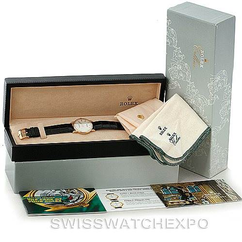 The image shows a Rolex Cellini 5115 Men's Yellow Gold Beige Dial 5115 Men's Yellow Gold Beige Dial watch in its open box, along with a cleaning cloth and informational booklets.