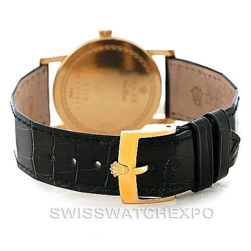 The Rolex Cellini 5115 Men's Yellow Gold Beige Dial 5115 Men's Yellow Gold Beige Dial watch is shown from the back, highlighting the gold buckle and black leather strap.