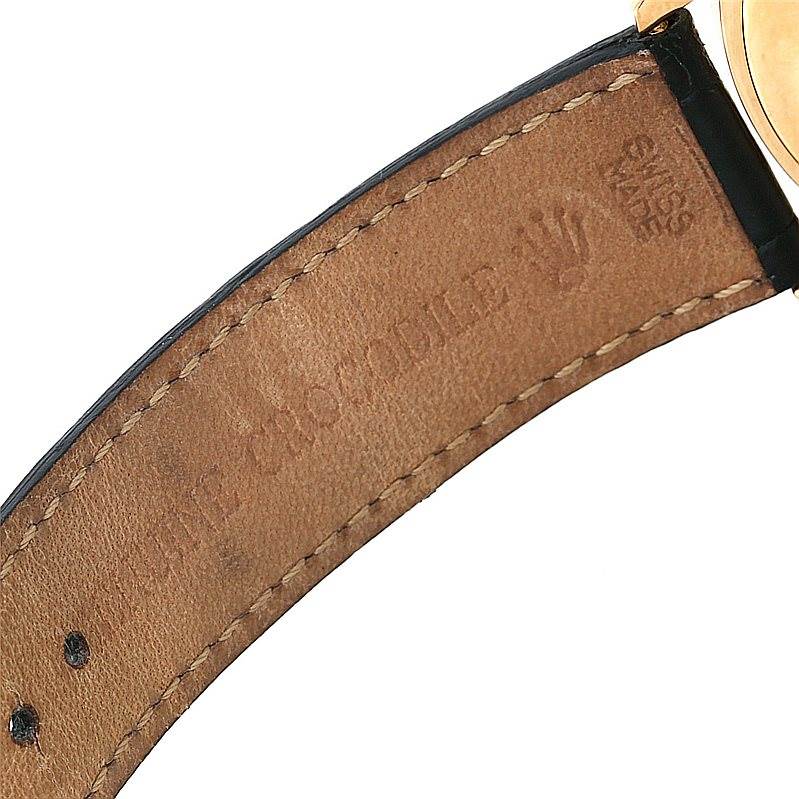The image shows the inner side of the leather strap of a Rolex Cellini 4233 Men's Yellow Gold White Dial 4233 Men's Yellow Gold White Dial watch, highlighting the stitching and branding.