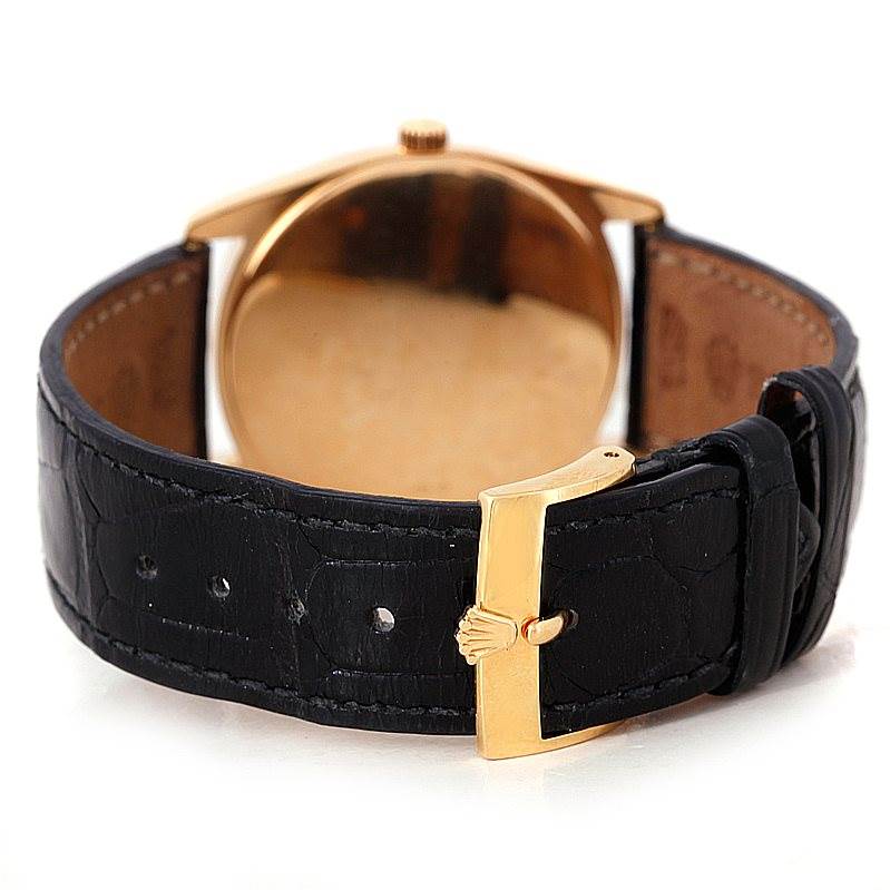 This image shows the rear view of a Rolex Cellini 4233 Men's Yellow Gold White Dial 4233 Men's Yellow Gold White Dial watch, highlighting the clasp and strap, with a focus on its gold buckle.