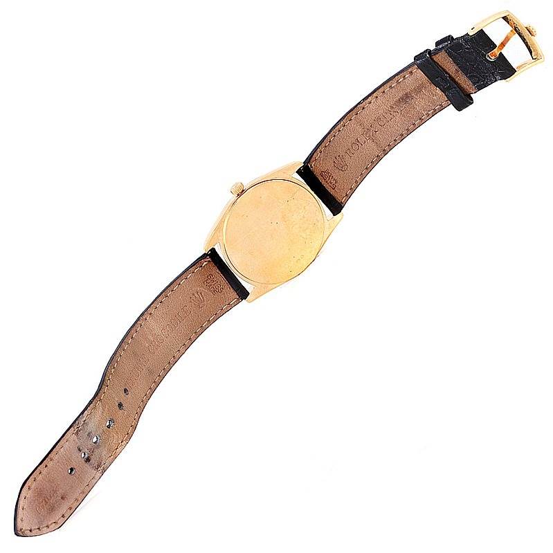 This image shows the back view of a Rolex Cellini 4233 Men's Yellow Gold White Dial 4233 Men's Yellow Gold White Dial watch with its leather strap fully extended.