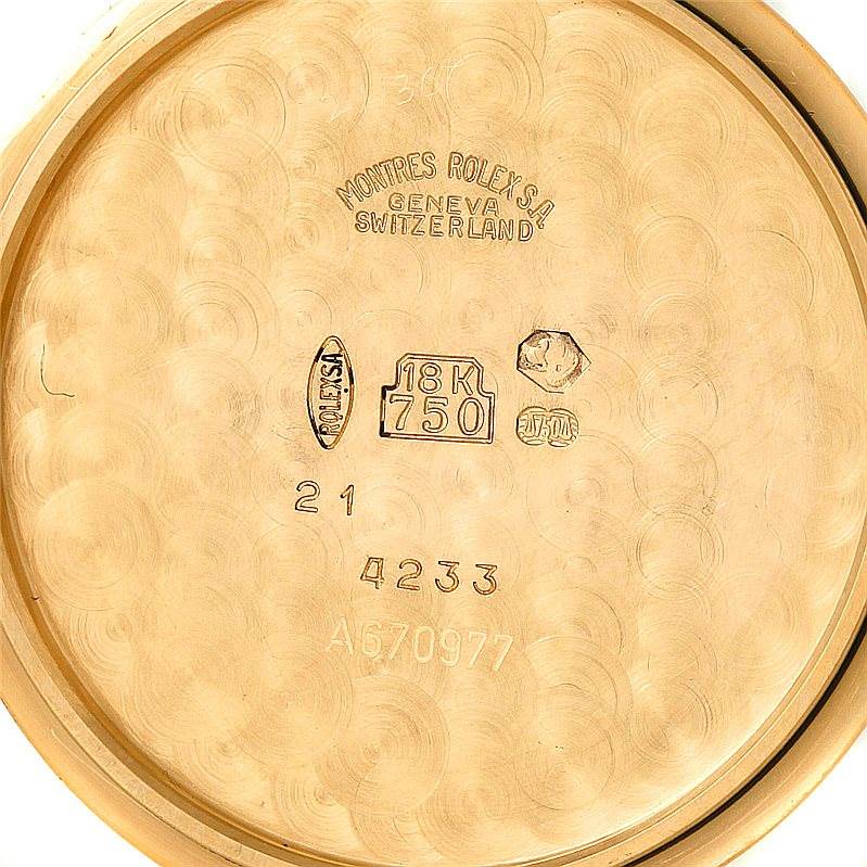 This image shows the inside back case of a Rolex Cellini 4233 Men's Yellow Gold White Dial 4233 Men's Yellow Gold White Dial watch, featuring engravings and hallmarks indicating 18K gold content.