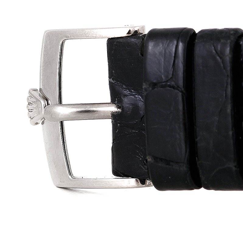 The image shows a close-up of a Rolex Cellini 5116 Men's White Gold Mother of Pearl Dial 5116 Men's White Gold Mother of Pearl Dial watch buckle with a black leather strap.