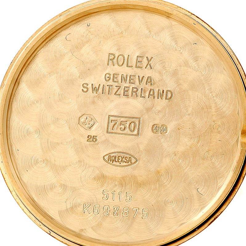 This is the interior view of the case back of a Rolex Cellini 5115 Men's Yellow Gold Mother of Pearl Dial 5115 Men's Yellow Gold Mother of Pearl Dial watch, showing various hallmarks and inscriptions.