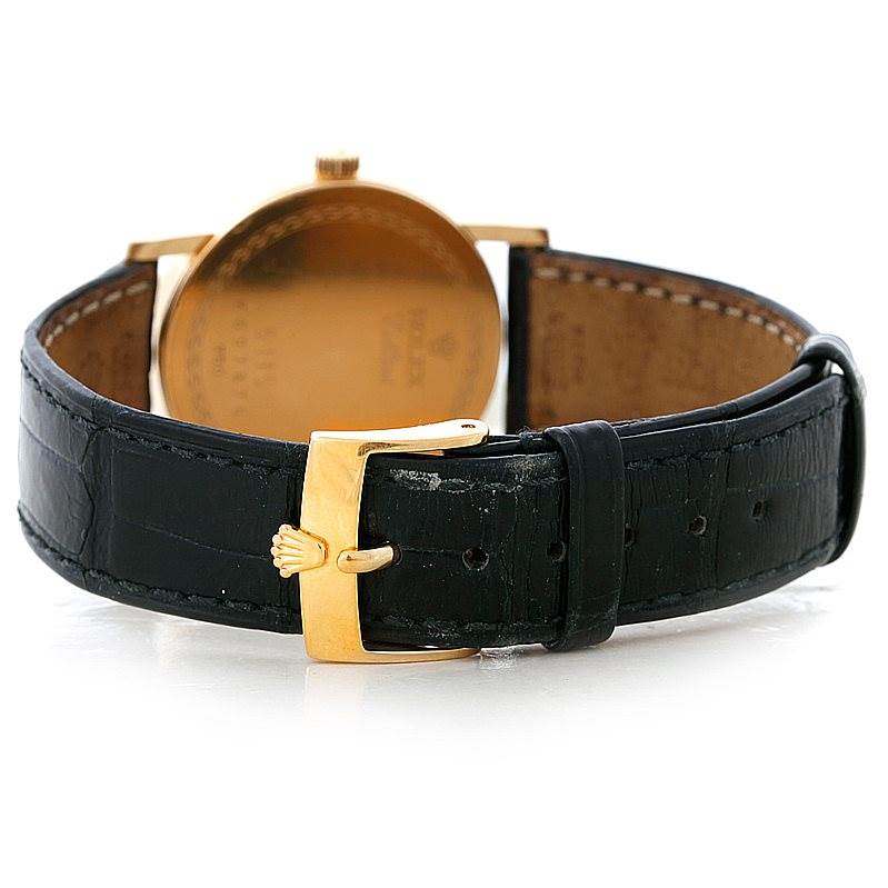 The image shows the back view of a Rolex Cellini 5115 Men's Yellow Gold Mother of Pearl Dial 5115 Men's Yellow Gold Mother of Pearl Dial watch, focusing on its black leather strap and gold buckle with the Rolex emblem.