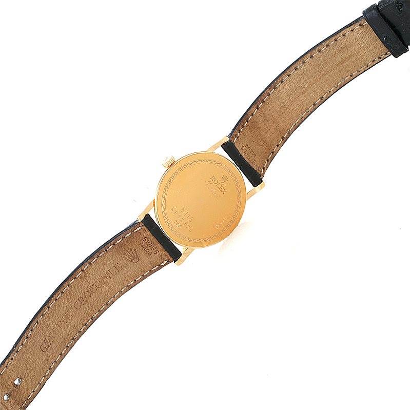 The image shows the back view of a Rolex Cellini 5115 Men's Yellow Gold Mother of Pearl Dial 5115 Men's Yellow Gold Mother of Pearl Dial watch, highlighting its leather strap and gold-colored case back.
